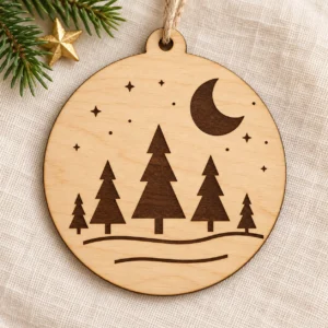 Moonlit Pines Christmas ornament SVG design with five pine trees, a crescent moon, and stars engraved on wood.