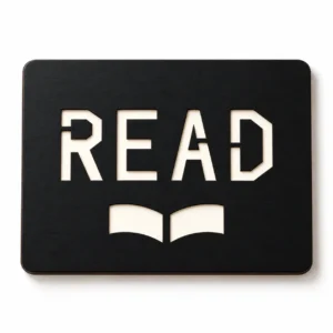 Illustrative monochrome mockup of the Quiet Chapter reading nook sign SVG, showing READ stencil lettering and an open-book motif on a rounded rectangular plaque.