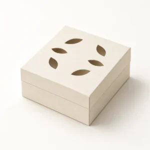 Illustrative cardstock mockup of the Verdant Fold gift box SVG, showing a removable botanical leaf-cutout lid.